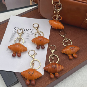 Breloque de sac et porte-clés en PVC, mignonne, légère, en forme de pain, de bretzel ou de croissant, avec nœud, accessoire de bijouterie pour sac à dos - Product Image 3