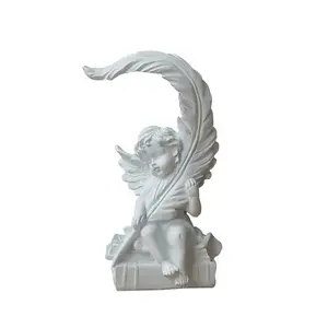 Resin feathered baby angels decorate the study table top sculpture
