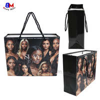 Sac en papier noir réutilisable de luxe avec poignée pour emballage de vêtements, cadeaux et achats professionnels, personnalisable et durable