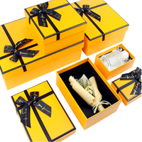 Boîte d'emballage cadeau en carton magnétique avec logo personnalisé orange avec nœud ruban bouquets de fleurs pour bougie spécifications de feuille de cadeau