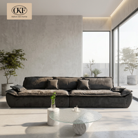 Canapé modulaire en tissu anthracite deux places en forme de L avec assise profonde, coussins d'accoudoir et dossier pour salon, villa, espace lounge contemporain
