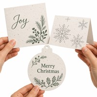 Carte de Noël en papier semence avec motif de verdure hivernale et de flocons de neige