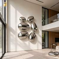 Sculpture murale en acier inoxydable poli miroir RELONG en forme de galet à vendre