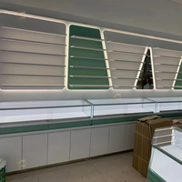 Vitrine de magasin de lunettes haut de gamme personnalisée, moderne, de luxe, en acier inoxydable, bois MDF, avec éclairage LED et acrylique, robuste