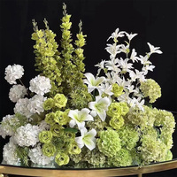 Composition florale artificielle d'hortensias verts, roses blanches et eucalyptus sur support doré pour allée de mariage et chemin de jardin