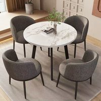 Ensemble table et chaises de style moderne, une table en métal avec panneau rembourré, quatre chaises en bois pour la maison ou l'hôtel