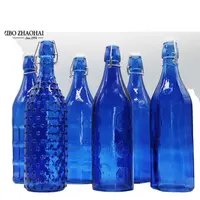 Botella de cristal cilíndrica vacía para vino y cerveza, color azul, con tapa abatible, barata, venta al por mayor