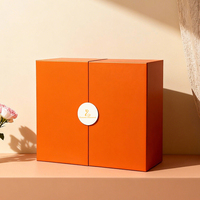 Boîte cadeau luxe sur mesure en papier rigide orange, double porte avec fermeture magnétique et tiroir, pour coffret de cosmétiques et de parfums.
