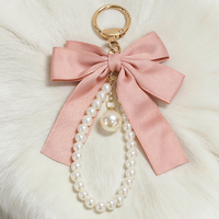 Porte-clés créatif polyvalent avec nœud papillon et petites perles, pendentif pour sac de téléphone portable pour femme