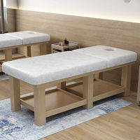 Table de massage pliable de salon commerciale moderne et luxueuse avec cadre en bois massif, acier inoxydable et revêtement en cuir synthétique, avec appui-tête intégré