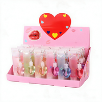 Best-seller transfrontalier : Brillant à lèvres effet miroir changeant de couleur, hydratant et repulpant, avec ornement suspendu en forme de coquille et de cœur