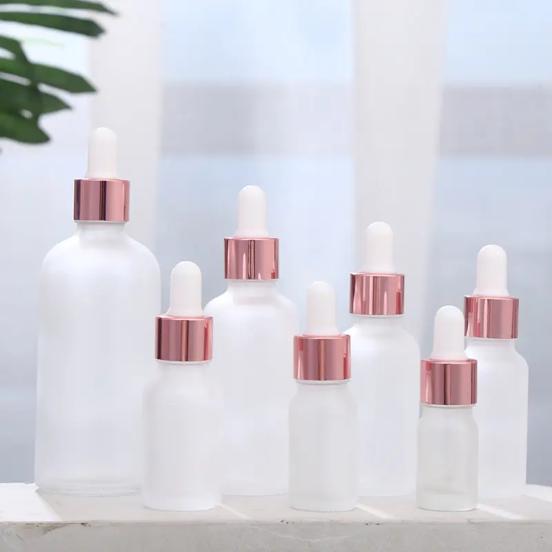 Essential oil bottle sets glass bottle with rose gold dropper caps empty cosmetic cuticle oil bottle for sale