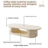 Table basse ovale blanc crème, base de rangement ouverte creuse, style minimaliste, profil bas, pour salon, table à thé