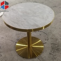 Depuis 2005, table basse ronde en marbre naturel sur mesure avec cadre doré et pieds en acier inoxydable doré.