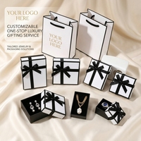 Ensemble d'emballage de luxe pour bijoux avec logo personnalisé, boîte rigide en carton et sac avec poignée en ruban noir pour marque, vente en gros