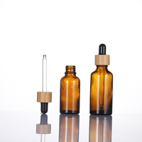 Flacon en verre ambré transparent de 100 ml avec compte-gouttes en bambou et bulbe noir brillant