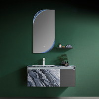 Meuble-lavabo suspendu minimaliste en acier inoxydable pour salle de bain avec miroir éclairé irrégulier