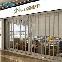 Vente en gros de porte électrique en alliage d'aluminium pour l'intérieur, avec volet roulant en cristal, porte coulissante pliable pour centre commercial, fabricant