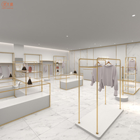 Stand d'exposition de vêtements en titane Service personnalisé à guichet unique Table de vitrine de conception de magasin entier pour magasin de vêtements