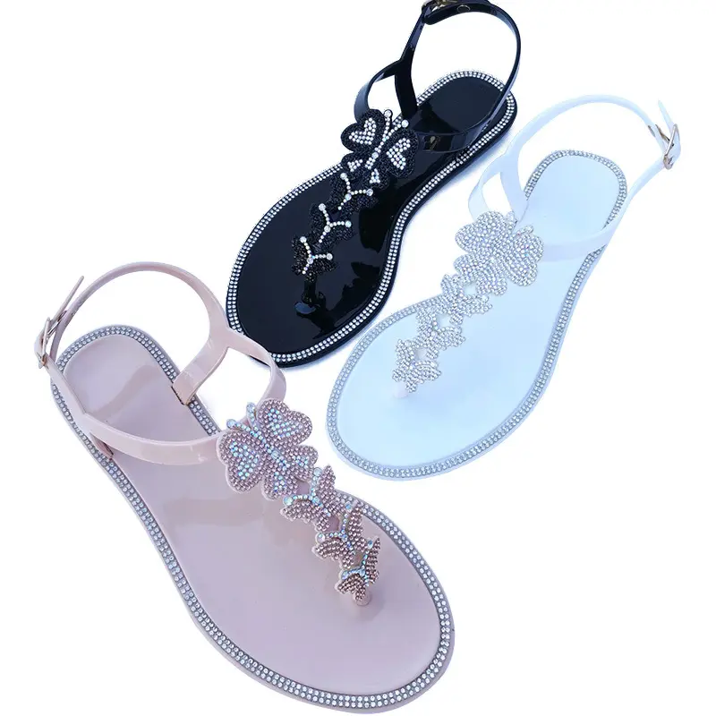 Sandalias de tacón plano con logotipo personalizado OEM ODM para mujer, zapatos de gelatina de PVC con punta redonda, chanclas de mariposa con diamantes de imitación, 15 días