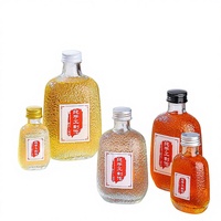 Bouteilles en verre sérigraphiées pour jus, fruits, vin et boissons avec bouchon rotatif en aluminium et design estampé or (100/200/300ml)