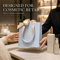 Sacs shopping en papier blanc de luxe personnalisés avec poignées en ruban longues pour l'emballage de marques de cosmétiques et de produits de beauté, vente en gros