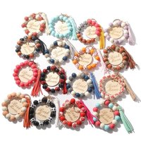 Pulsera de cuentas de madera de leopardo, llavero de cuerda elástica, borla tallada a mano, llavero de pulsera de disco