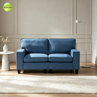 Nouvel ensemble de canapés en tissu au design minimaliste, 2 et 3 places, avec accoudoirs carrés épais et pieds en bois foncé mat, idéal pour les salons familiaux ou plans ouverts.