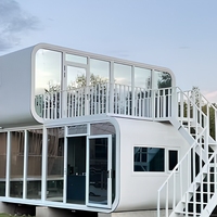 Maison préfabriquée modulaire de luxe à deux étages, type « Apple Cabin », avec terrasse et escalier, pour usage en hôtel, villa ou maison d'hôtes en station balnéaire