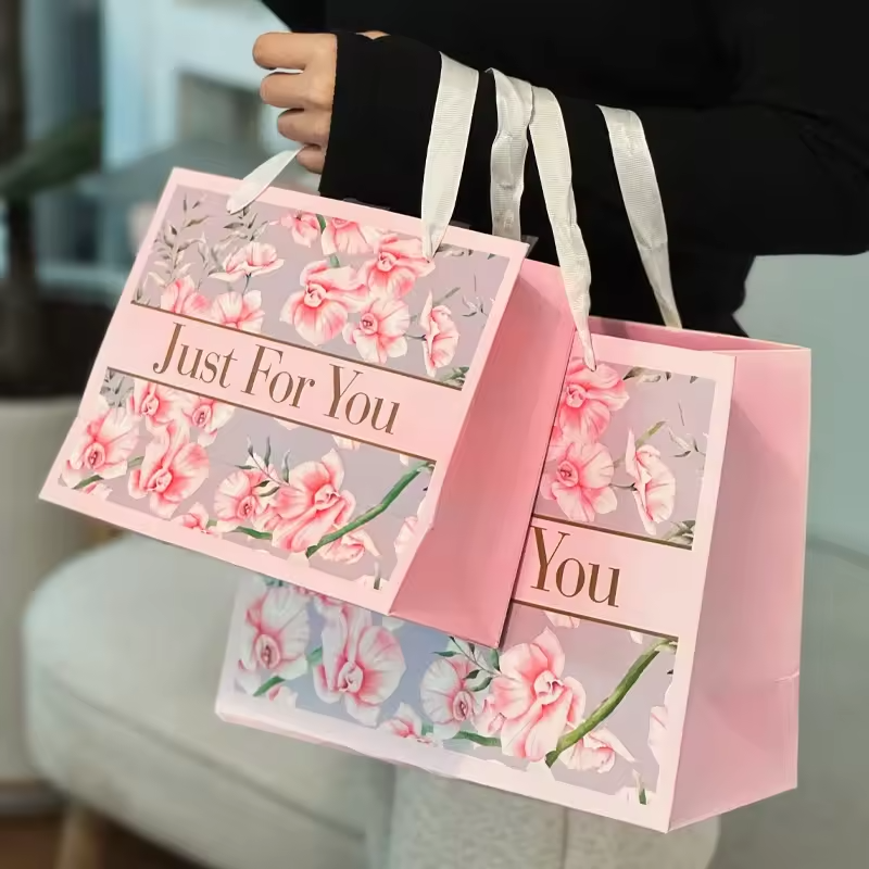 Wholesale Custom Brand Logo Design Promotion Luxury Clothing Retail Gift Shopping Pink Jewelry Paper Bag With Ribbon Handle