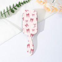 Brosse à cheveux démêlante portable style Coquette avec motif nœud léopard et coussin d'air, peigne de massage à palettes pour femmes