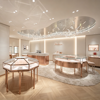 Meubles de magasin de bijoux de luxe sur mesure, vitrine hexagonale ronde en verre or rose pour boutique de détail