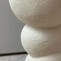 Table d'appoint fabriquée à la main en argile sculptée finie en blanc cassé mat apportant une beauté unique à la maison