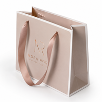 Sac fourre-tout de luxe personnalisé rose poudré en carton rigide ivoire, avec estampage à chaud or rose, pour boutiques, vente au détail et coffrets de marques de mode