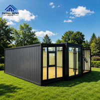 Maison préfabriquée extensible à double aile pour projets résidentiels de jardinage, avec entrée centrale, en acier, type conteneur, pour entrepôt