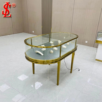Moderne Runde Schwarze Edelstahl-Schmuckvitrine mit Rotierendem LED-Licht Glasinselschrank für Einzelhandel und Boutiquen
