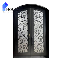 Porte d'entrée en fer forgé de style français exquis avec un dessus cintré, du verre gravé floral et une finition noire patinée