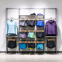 Porte-vêtements robuste en métal gris avec panneau grillagé, barre de suspension, roulettes et étagères, autoportant, CE ETL, vente en gros pour boutiques