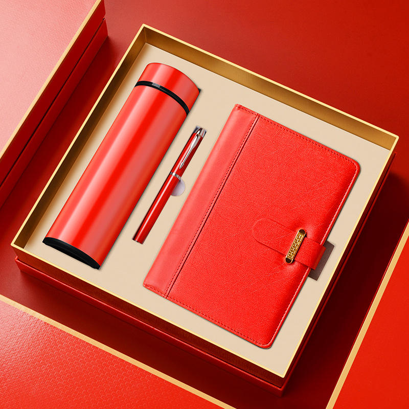 Red thermos cup, pen and notebook