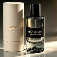 Flacon atomiseur de parfum cylindrique haut de gamme gris fumé à base épaisse, avec fond créatif en forme de montagne de glace et capuchon noir brillant, en verre personnalisé