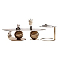 Table basse moderne simple et légère de luxe en acier inoxydable avec boule ronde Combinaison de table basse ovale à panneau de roche pour petit salon