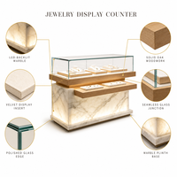 Comptoir de présentation de bijoux personnalisé en bois et marbre avec vitrine en verre éclairée pour magasin de bijoux en gros