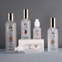 Nouveauté Flacons en verre givrés à pompe à lotion à épaule inclinée Emballage de soins de la peau avec pompe dorée 30ml 50ml 75ml 100ml 200ml