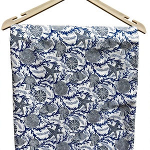 Tela con temática náutica vibrante, con un fondo blanco adornado con intrincados patrones azules y azul oscuro de conchas marinas. - Product Image 1
