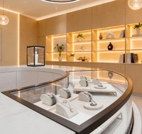 Comptoir d'îlot de présentation de bijoux en aluminium de luxe sur mesure avec cadre blanc premium et éclairage LED pour magasin de détail