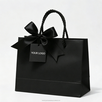 Sacs cadeaux noirs de luxe personnalisables avec ruban et étiquette, en matériaux recyclés, pour la vente au détail haut de gamme de bijoux, vêtements, chaussures et boutiques.