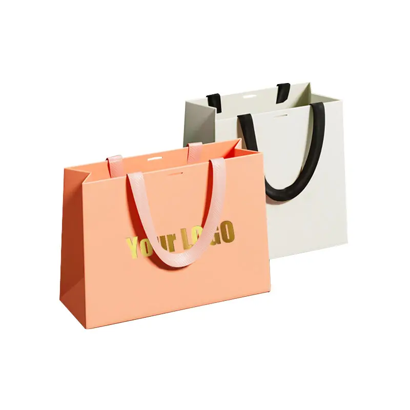 شعار مخصص مطبوع مقبض شريط فاخر أكياس ورقية وردية اللون للتغليف للتسوق البوتيك مع شعارك الخاص