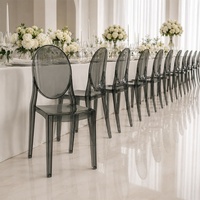 Chaise Ghost en polycarbonate transparent gris fumé pour événements, mariages, chaise de salle à manger d'hôtel à dossier ovale moderne