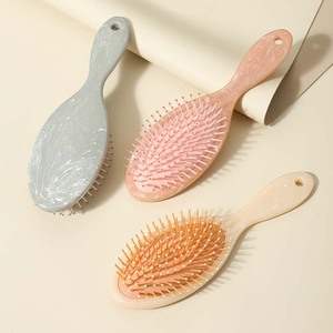 2025 ecológico nueva moda diseño único cojín de aire desenredante cepillo para el cabello húmedo y seco cepillo de pelo de mármol peine - Product Image 1