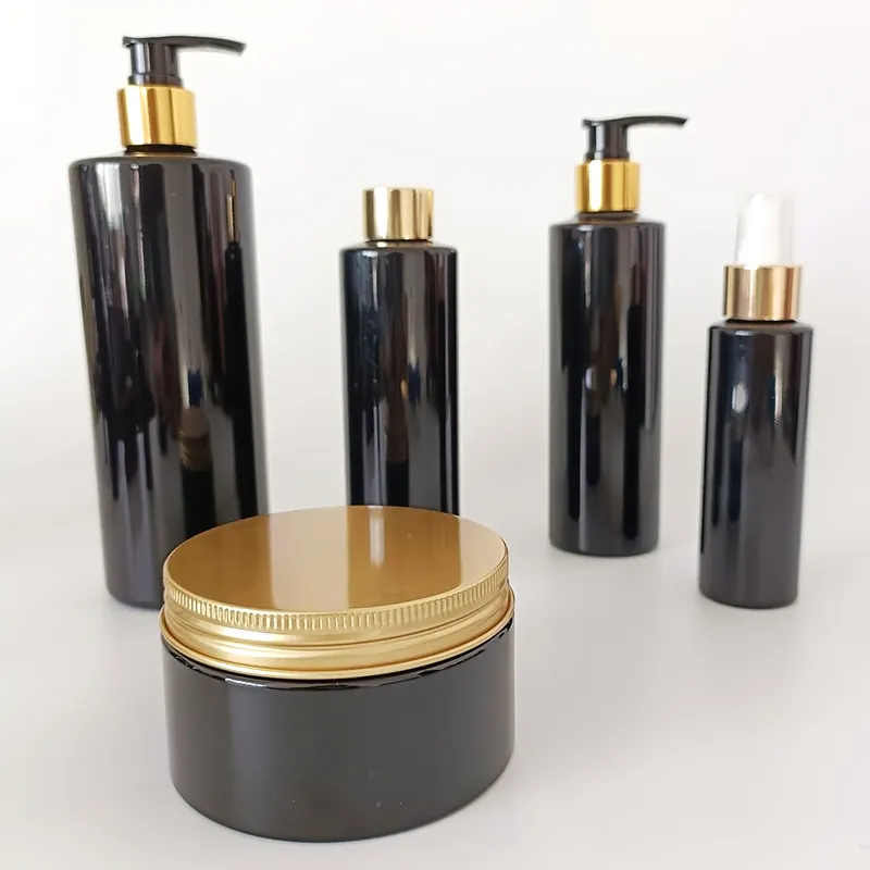 Flaschen- und Gläser-Set schwarzfarbige Verpackung Kosmetika Hautpflege Creme Serum Shampoo leer aus Kunststoff kundenspezifisch luxuriös mit goldenen Deckeln HF